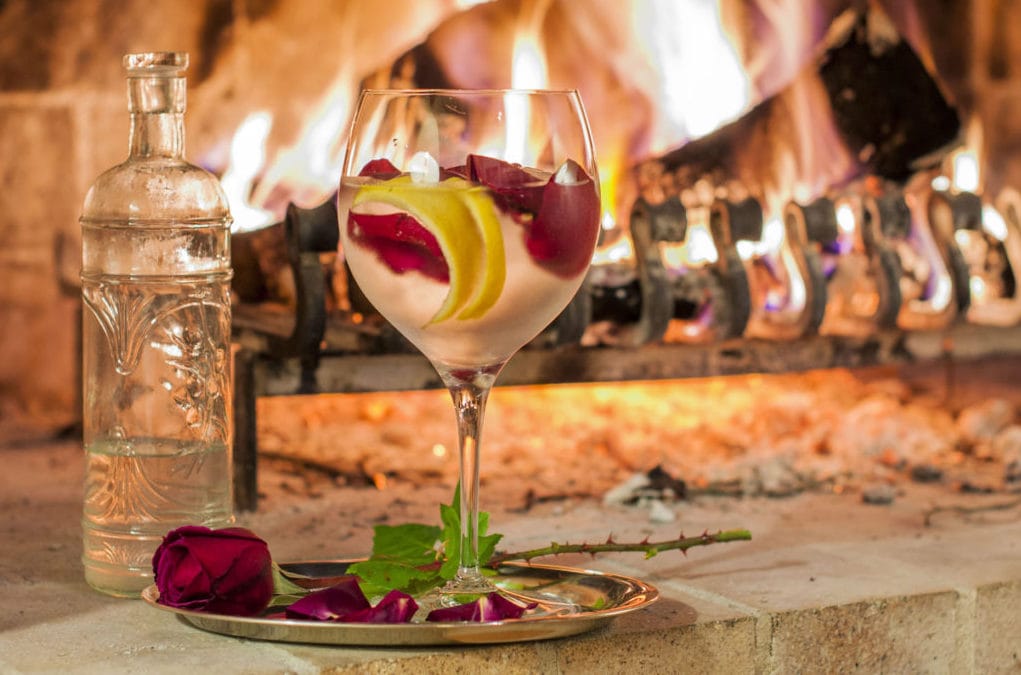 drink and roses by fireplace